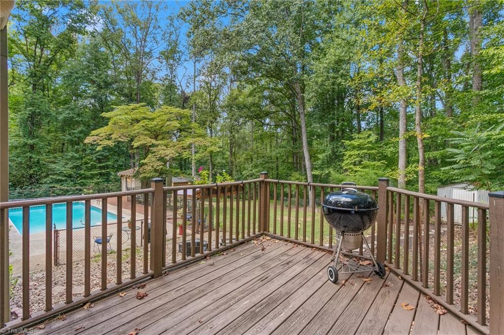 Grilling deck overlooking serene backyard oasis - 7206 Haw Ridge Road, Summerfield NC 27358, Summerfield