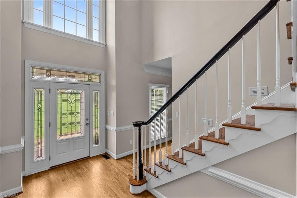 A dramatic 2-story foyer welcomes you with abundant natural light and a leaded glass front door, sidelights and transom window. - 6101 Trotter Ridge Road, Summerfield NC 27358, Summerfield