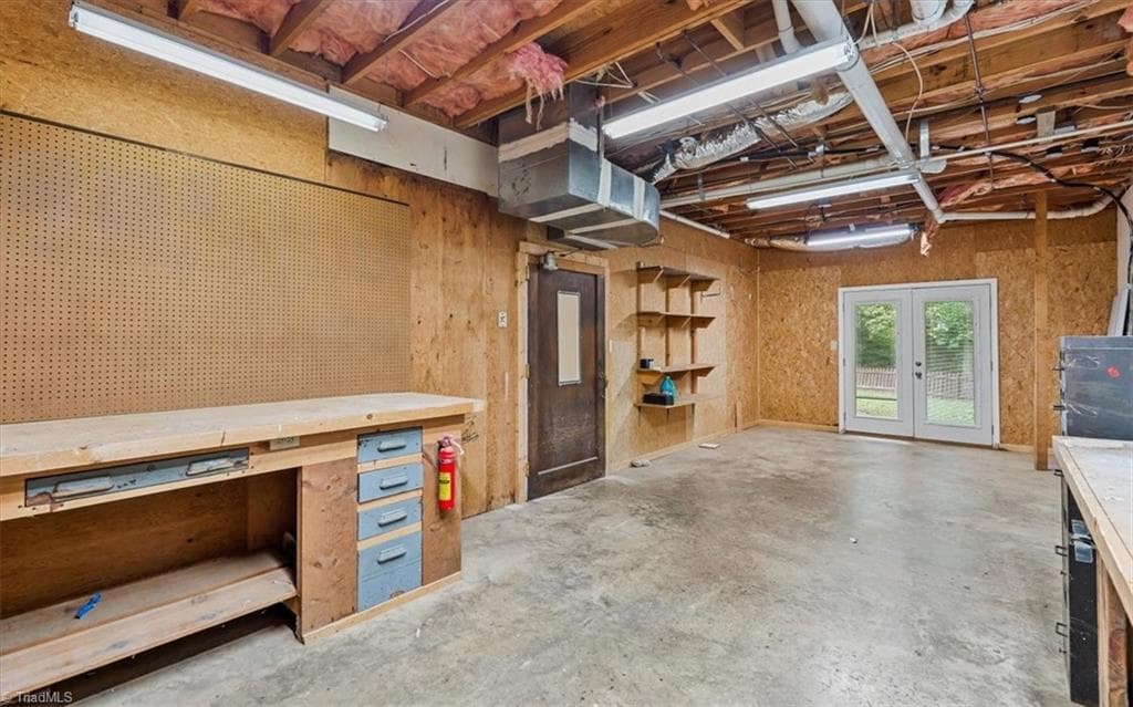 Basement workshop with double door entrance. - 6101 Trotter Ridge Road, Summerfield NC 27358, Summerfield