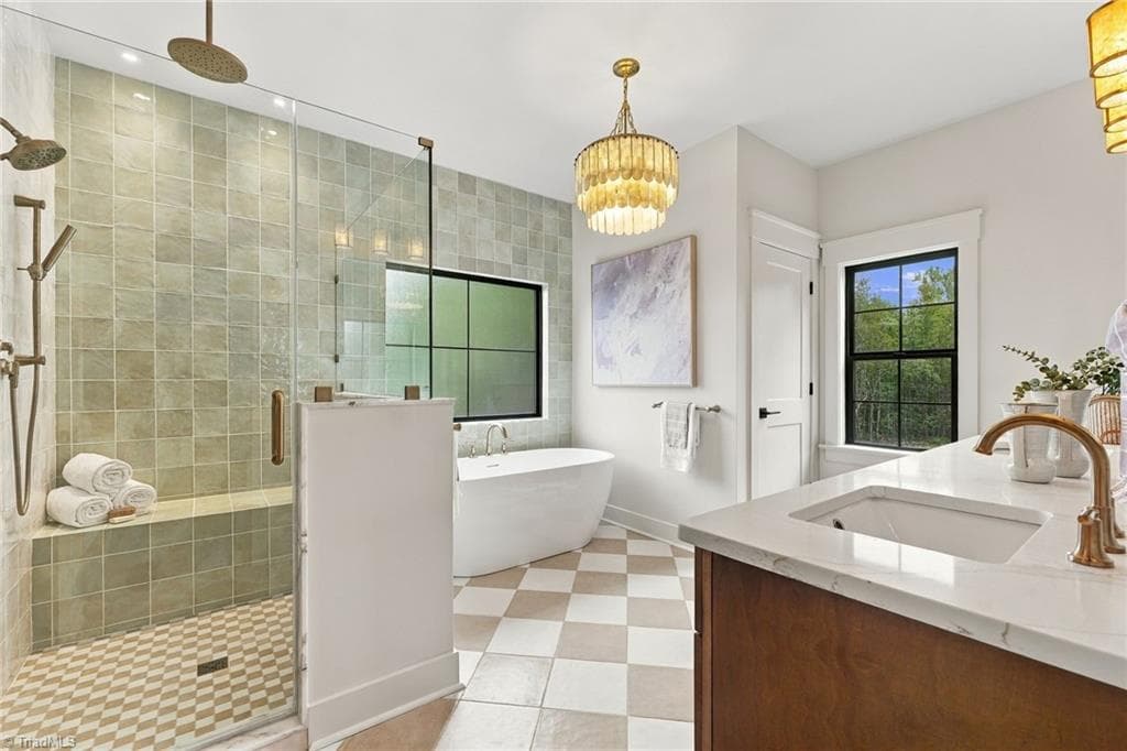 A truly breathtaking spa-inspired retreat, this luxurious bath features an oversized custom shower and a stunning freestanding soaking tub! - 224 Pearson Farm Road, Summerfield NC 27358, Summerfield
