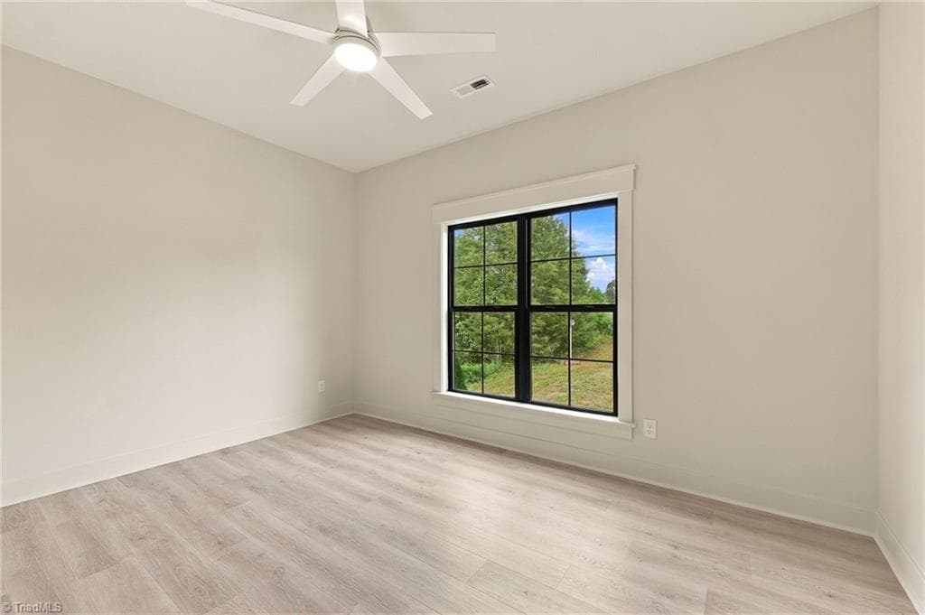 Third bedroom on the front of the home ~ Gorgeous recycled Laminate flooring throughout the entire home! - 224 Pearson Farm Road, Summerfield NC 27358, Summerfield