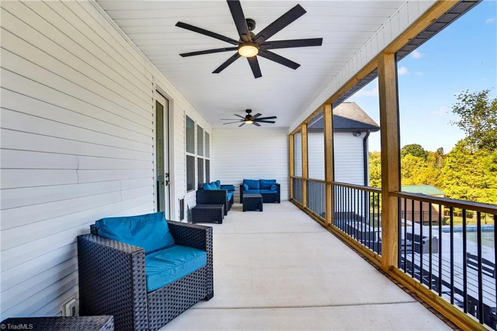 Ceiling fan and seating on the back porch - 117 Scenic View Trail, Madison NC 27025, Madison