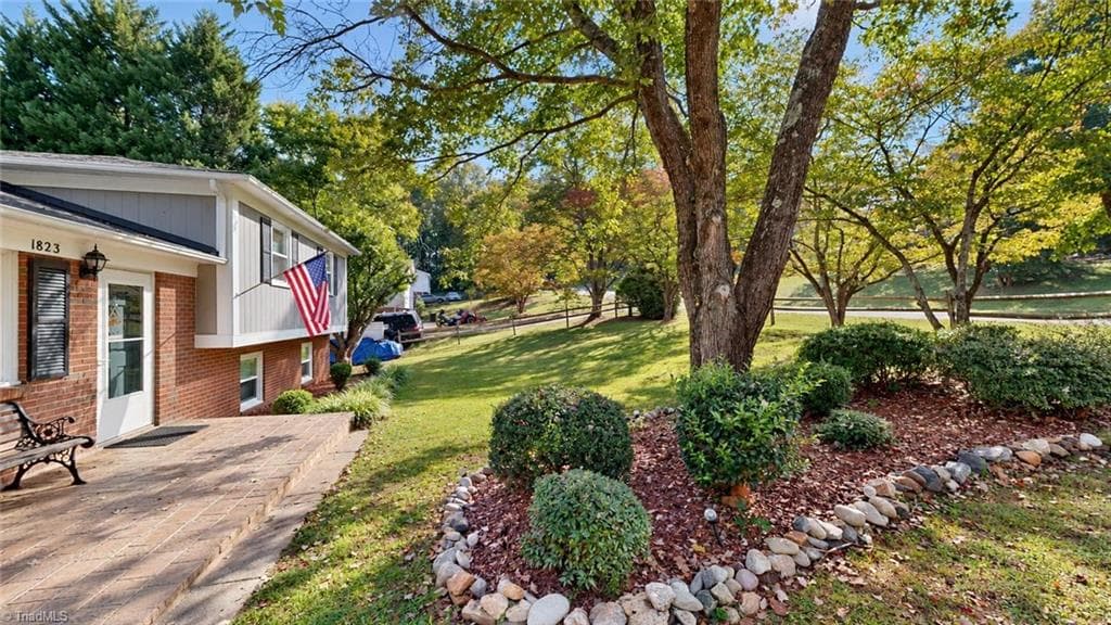 Front yard shows lovely landscaping and the front porch - 1823 Bantry Trail, Kernersville NC 27284, Kernersville
