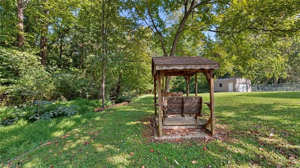 Edge of the yard near the creek is this inviting swing - 1823 Bantry Trail, Kernersville NC 27284, Kernersville