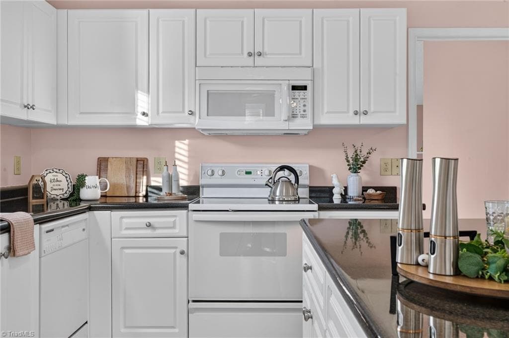 White cabinetry keeps the kitchen feeling fresh and bright. - 4407 Cove Cay Lane, Greensboro NC 27410, Greensboro