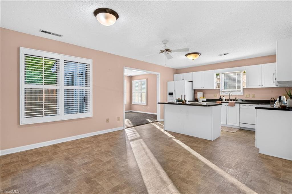 From the dining area, the kitchen feels connected to the rest of the home—perfect for conversation while meals are being prepared. - 4407 Cove Cay Lane, Greensboro NC 27410, Greensboro