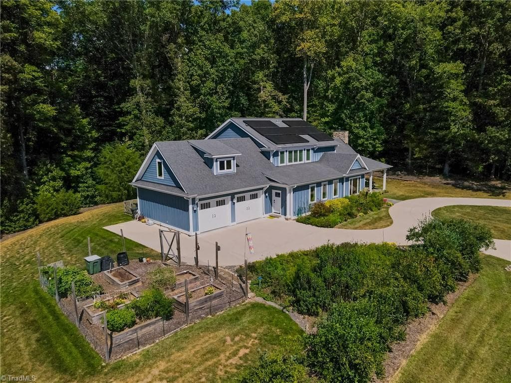~30 mature blueberry bushes along the Southern border; six cedar raised beds in the enclosed garden; parking pad next to garage for 3rd vehicle - 3925 Thorndale Drive, Winston-Salem NC 27106, Winston-Salem