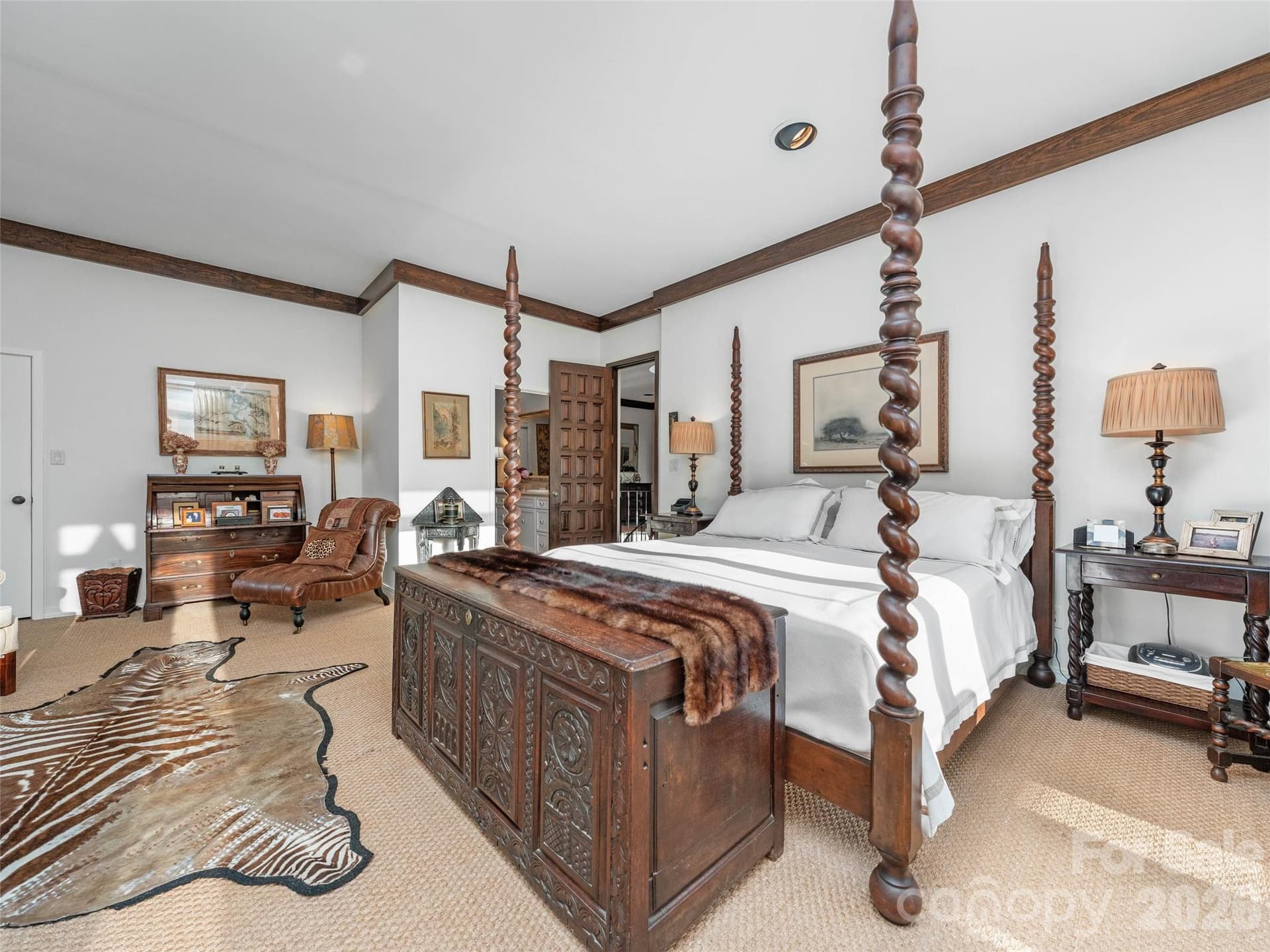 The four-poster bed anchors a bedroom designed for rest and elegance. - 65 Crestwood Road, Asheville