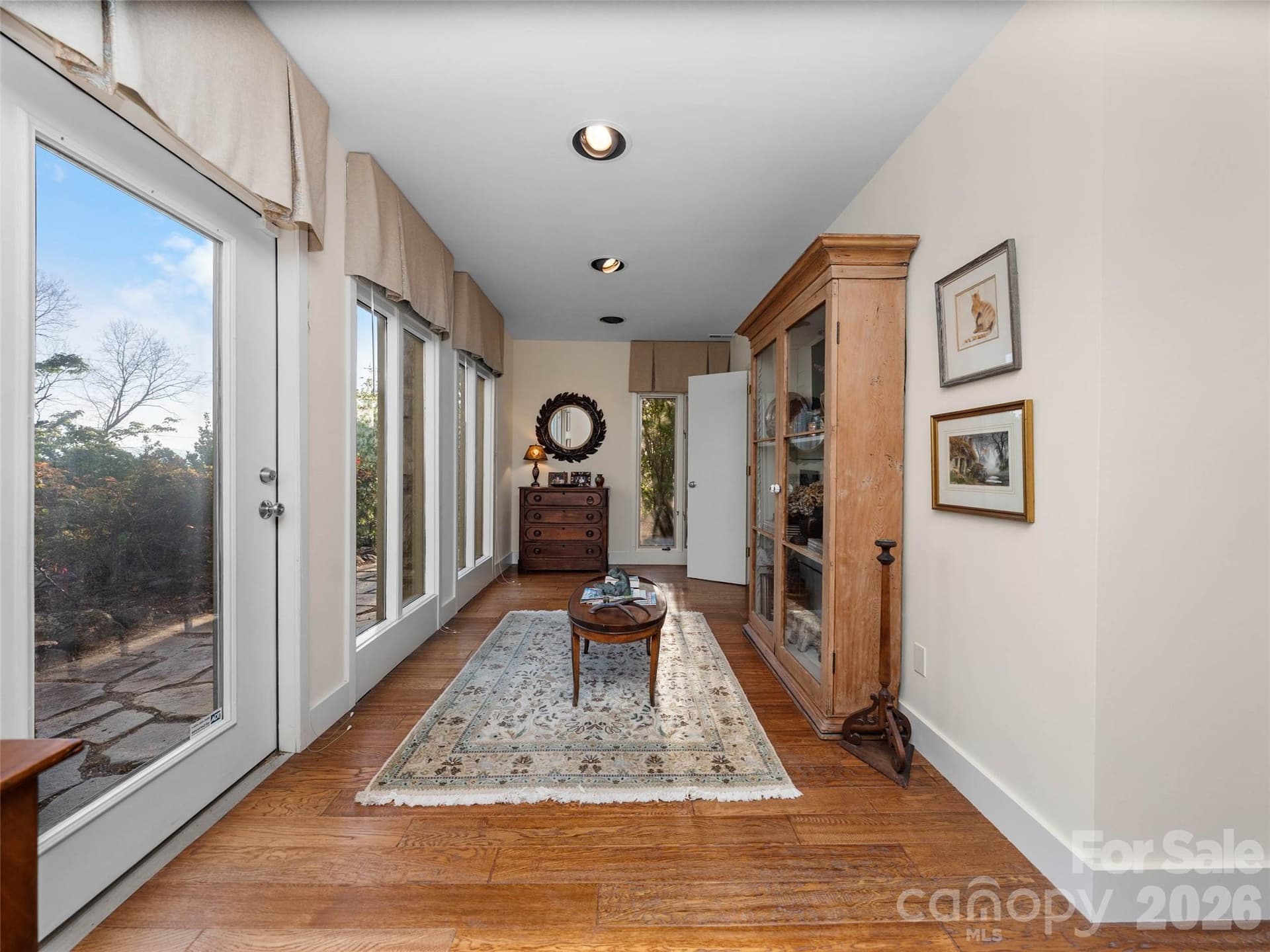 Floor-to-ceiling windows bring the beauty of the gardens indoors. - 65 Crestwood Road, Asheville