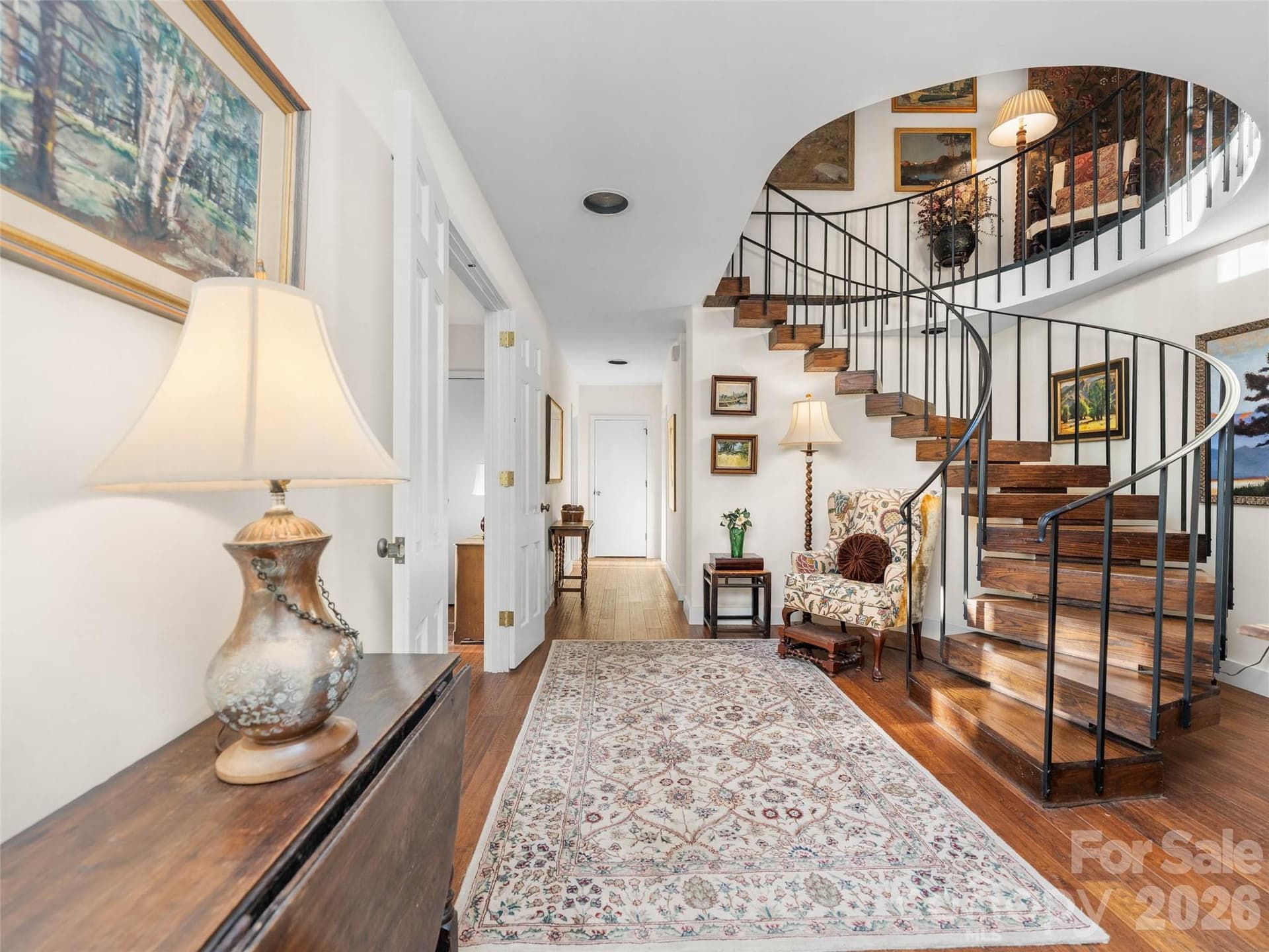 The staircase leads to inviting lower-level living surrounded by gardens and natural light. - 65 Crestwood Road, Asheville