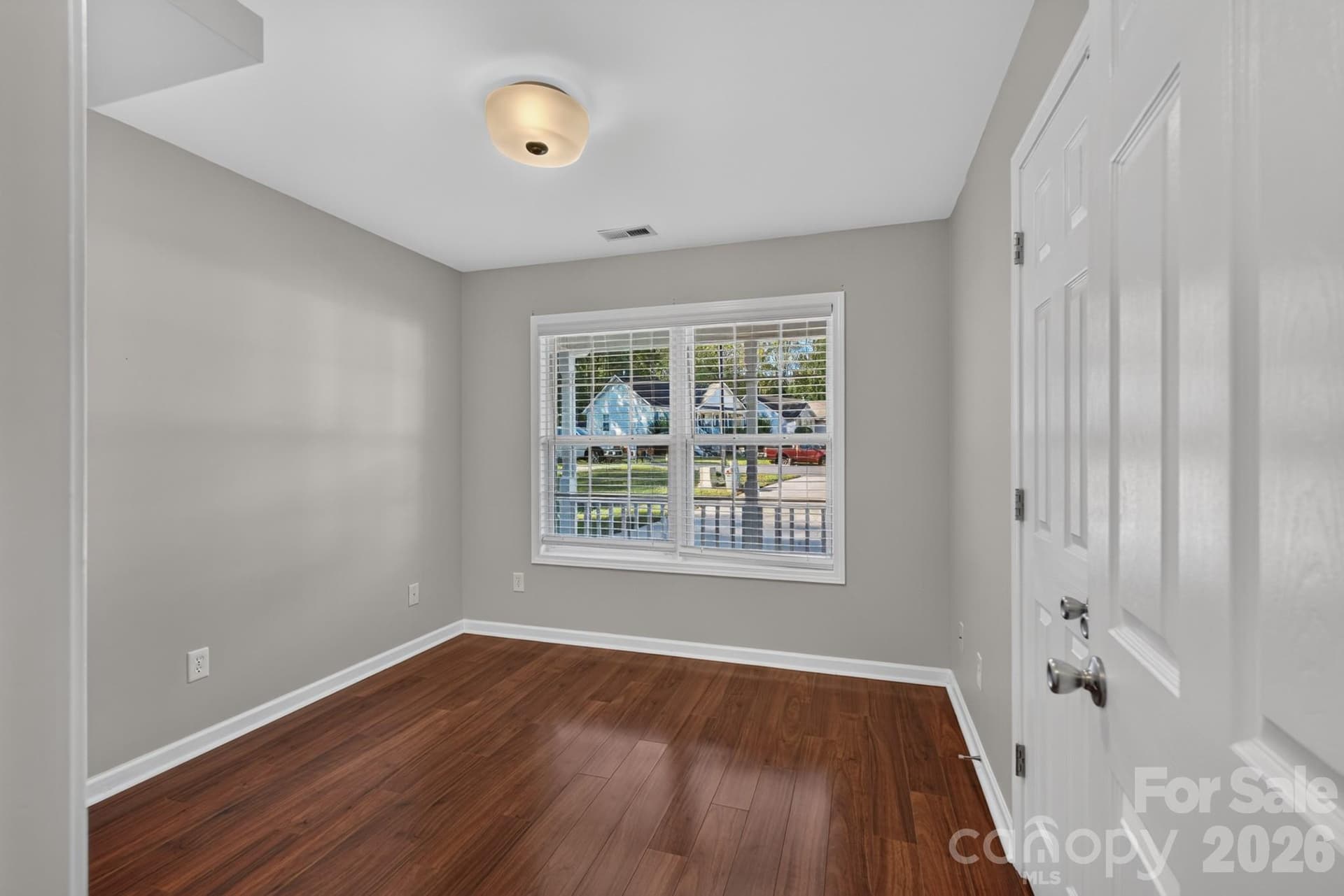 Generously sized second bedroom complete with gleaming hardwood floors and ample closet storage. - 702 Painted Lady Court, Rock Hill