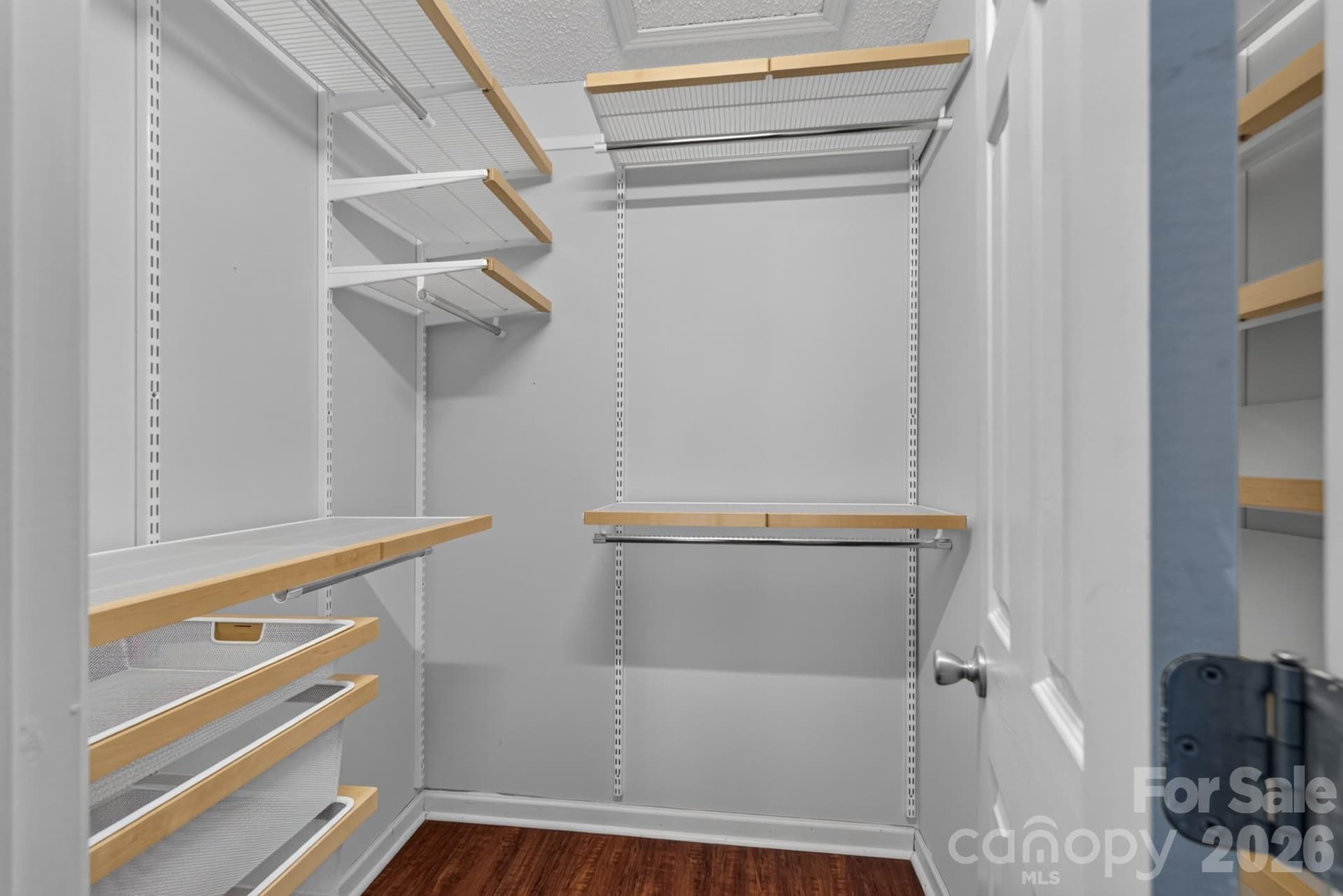 Generous walk-in closet with built-in custom wire shelving for maximum organization. - 702 Painted Lady Court, Rock Hill