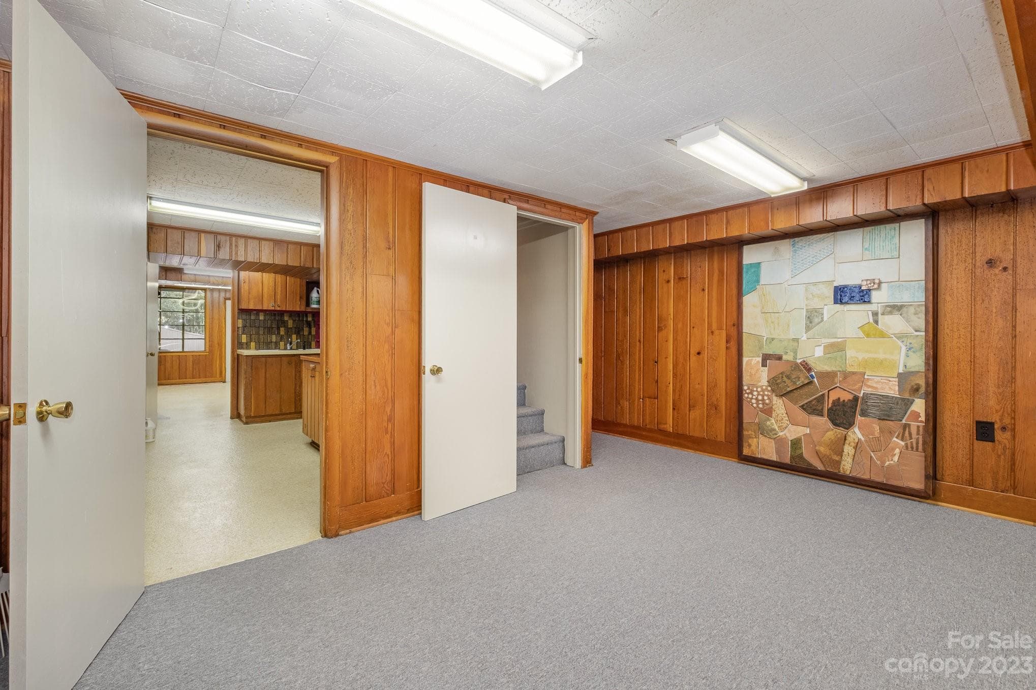 This piece of art will stay. The door leads to Utility, office/craft/art room. - 2756 Peachtree Road, Statesville