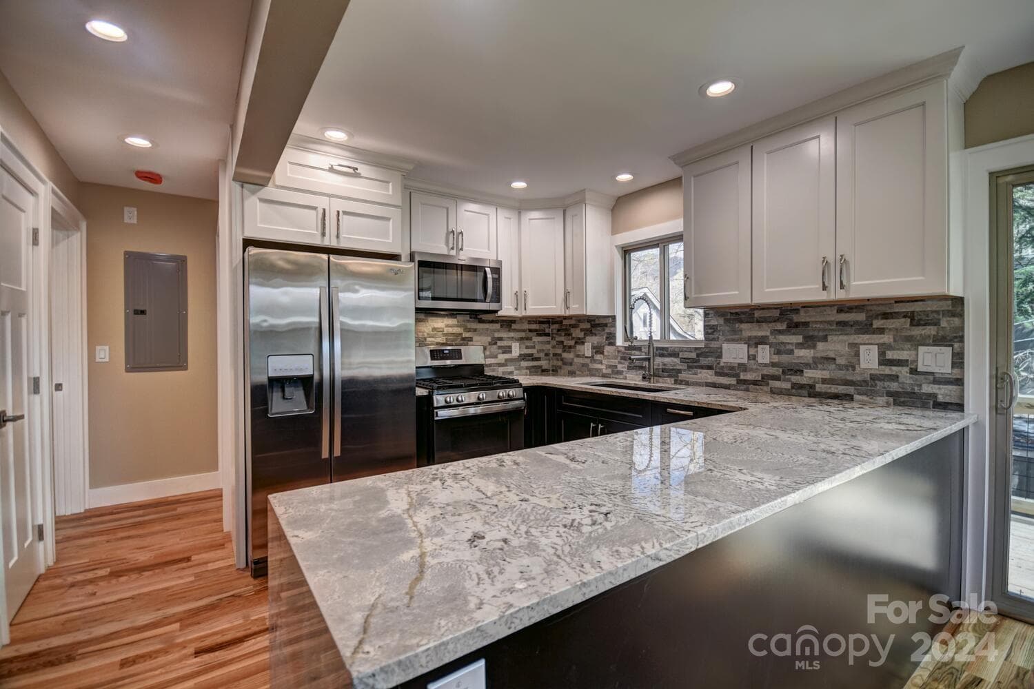 Kitchen with Water Fall Granite Counter Top & Tile Backsplash - SS Gas Range- SS DBL Door Refrigerator Microwave/Vent hood - vented to the outside - Commercial Faucet with Pot Filler - Kohler Sink - Woodlands Village, Maggie Valley