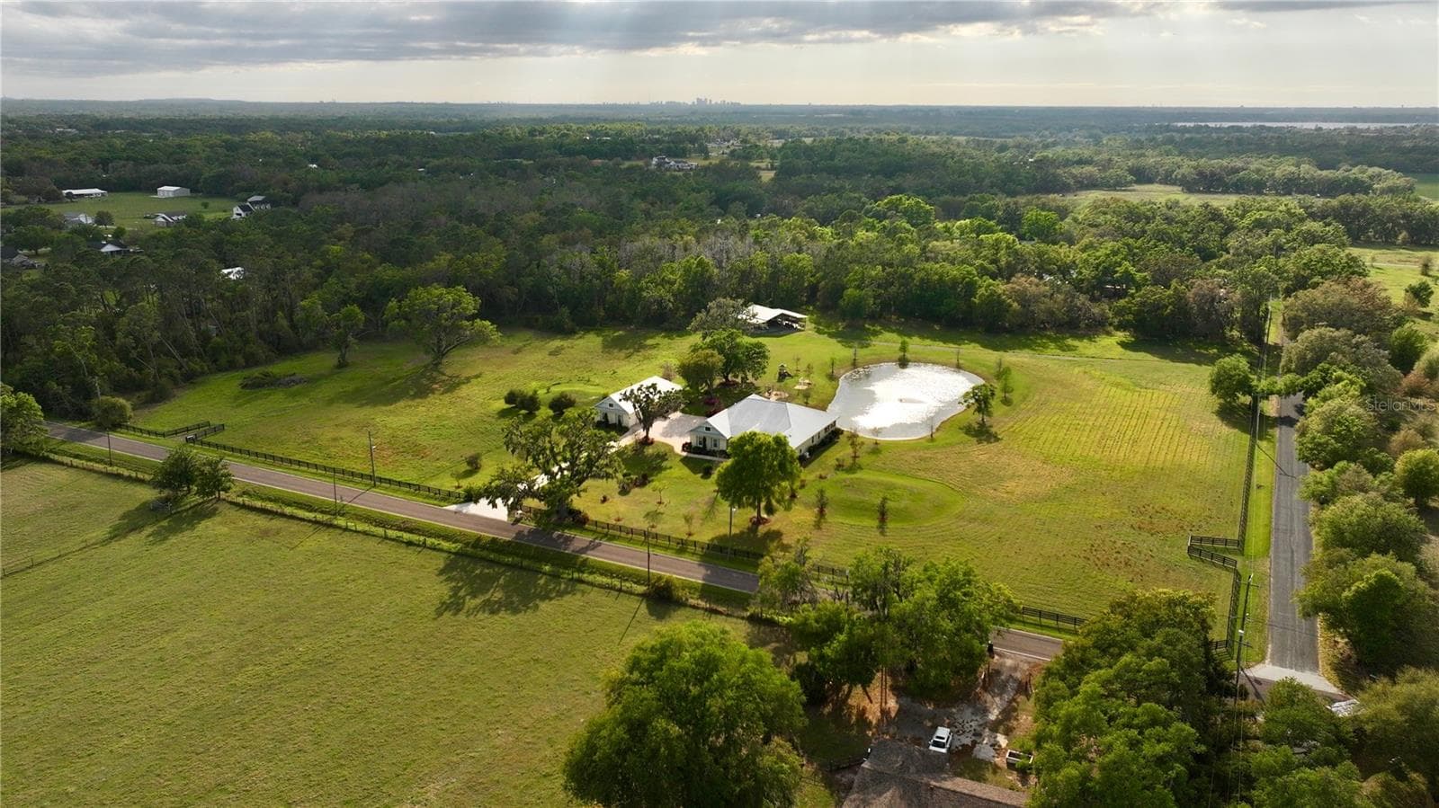 Fenced estate features the main house, a guest cottage, a pond, a creek and pole barn - 3709 GALLAGHER RD, PLANT CITY