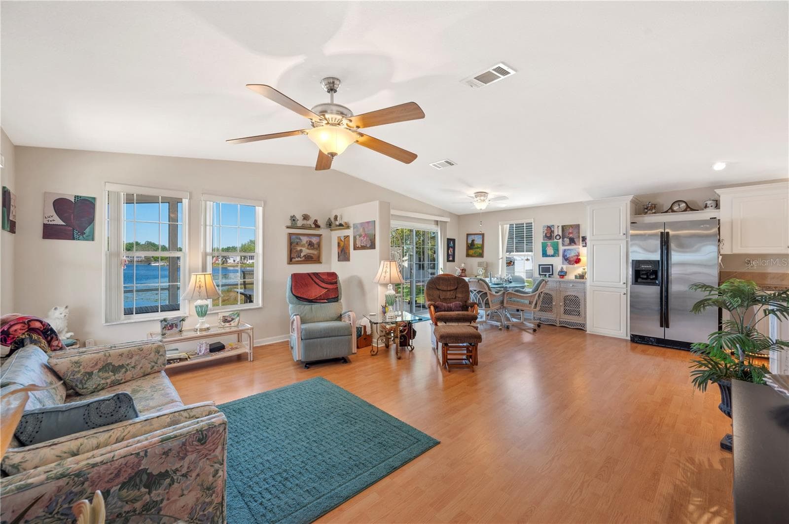 Open floor plan - living room / dining room combo with sliding glass door that open up to the screened porch. - 38 QUEEN OF WATERS ST, LAKE WALES