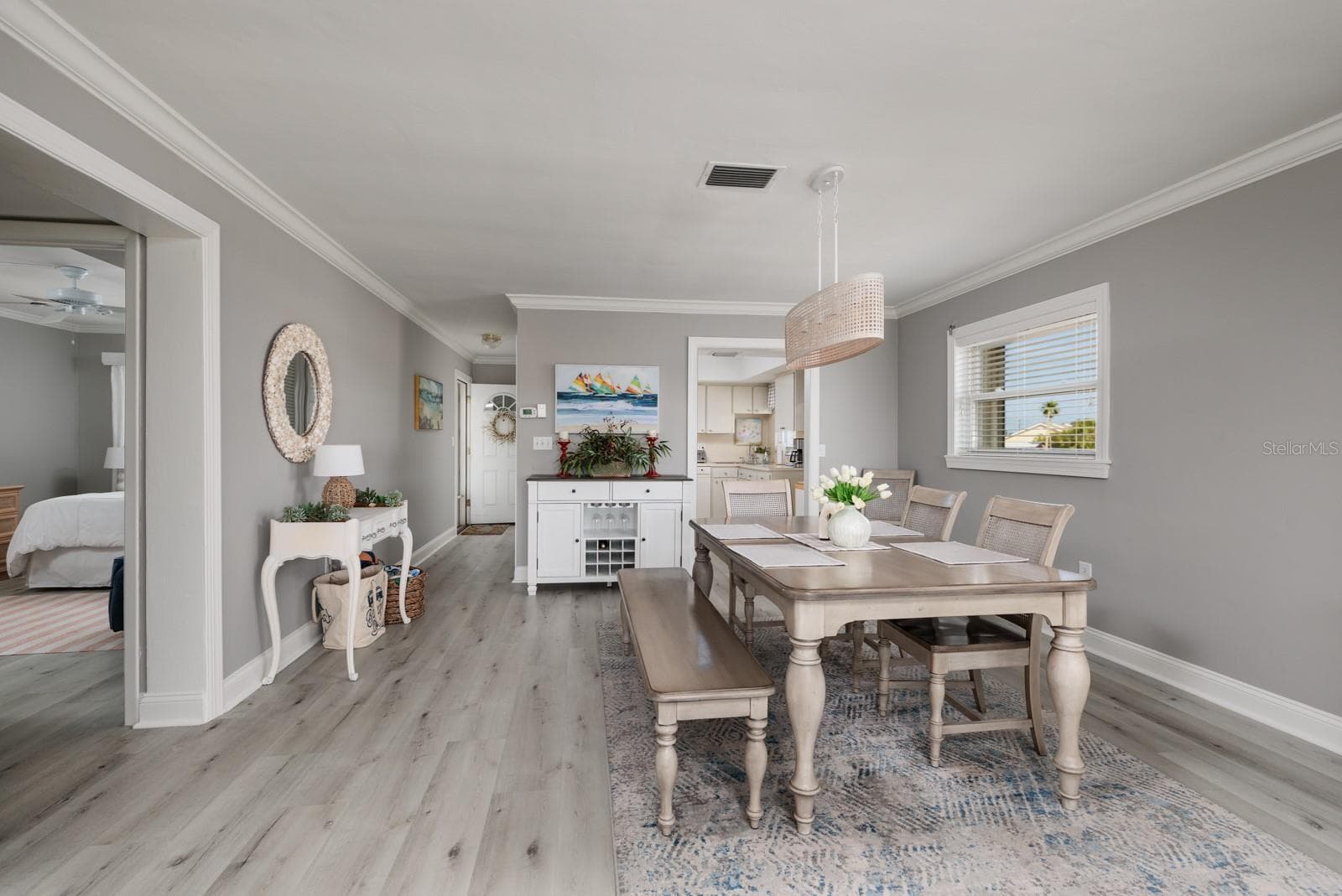 Dining area w/Crown Molding. Doorway to kitchen. 2nd bedroom on left. Side window w/Hurricane shutter. - 6161 GULF WINDS DR #338, ST PETE BEACH