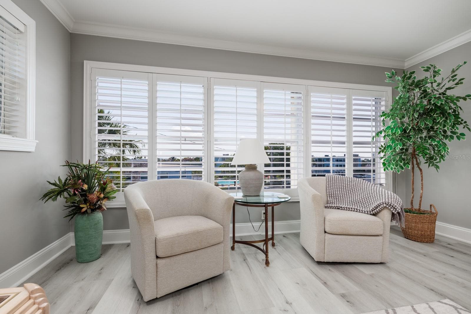 Large living room window w/pool & bay views. Plantation shutters. Window faces southeast. Hurricane Shutter. - 6161 GULF WINDS DR #338, ST PETE BEACH