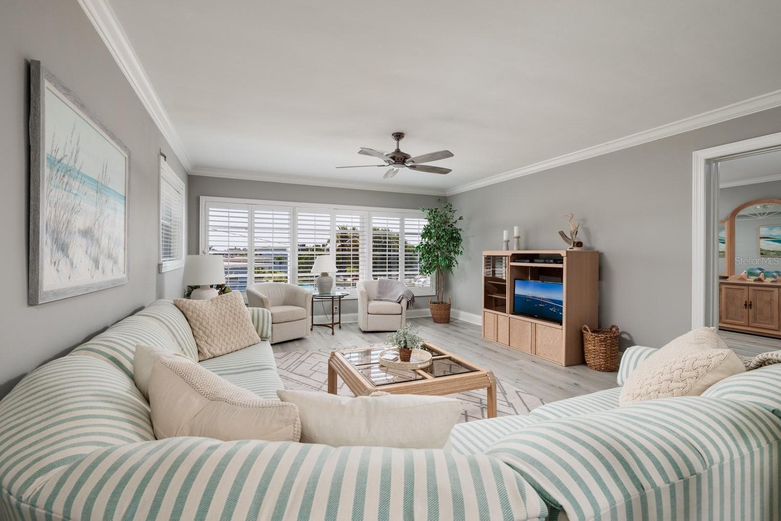 Living room & doorway to primary bedroom on right. - 6161 GULF WINDS DR #338, ST PETE BEACH