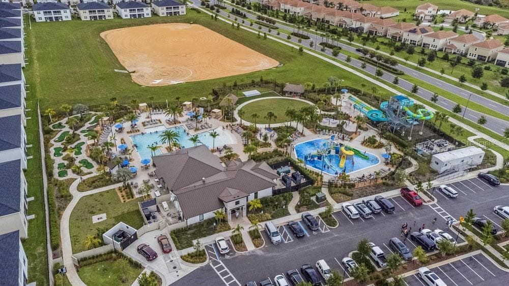 Aerial view of community pool with water park at Oasis Clubhouse - 1148 KINGSBARN ST, DAVENPORT