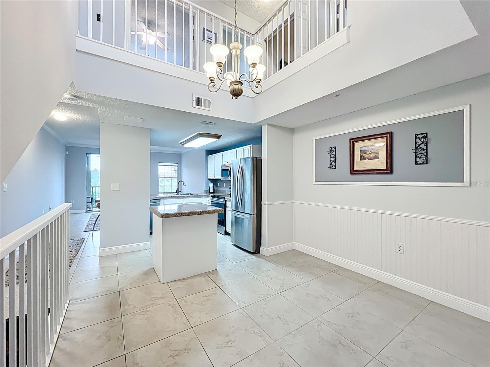 Main living areas are on 2nd floor with the kitchen as the central hub. - 5459 BENTGRASS DR #2-116, SARASOTA
