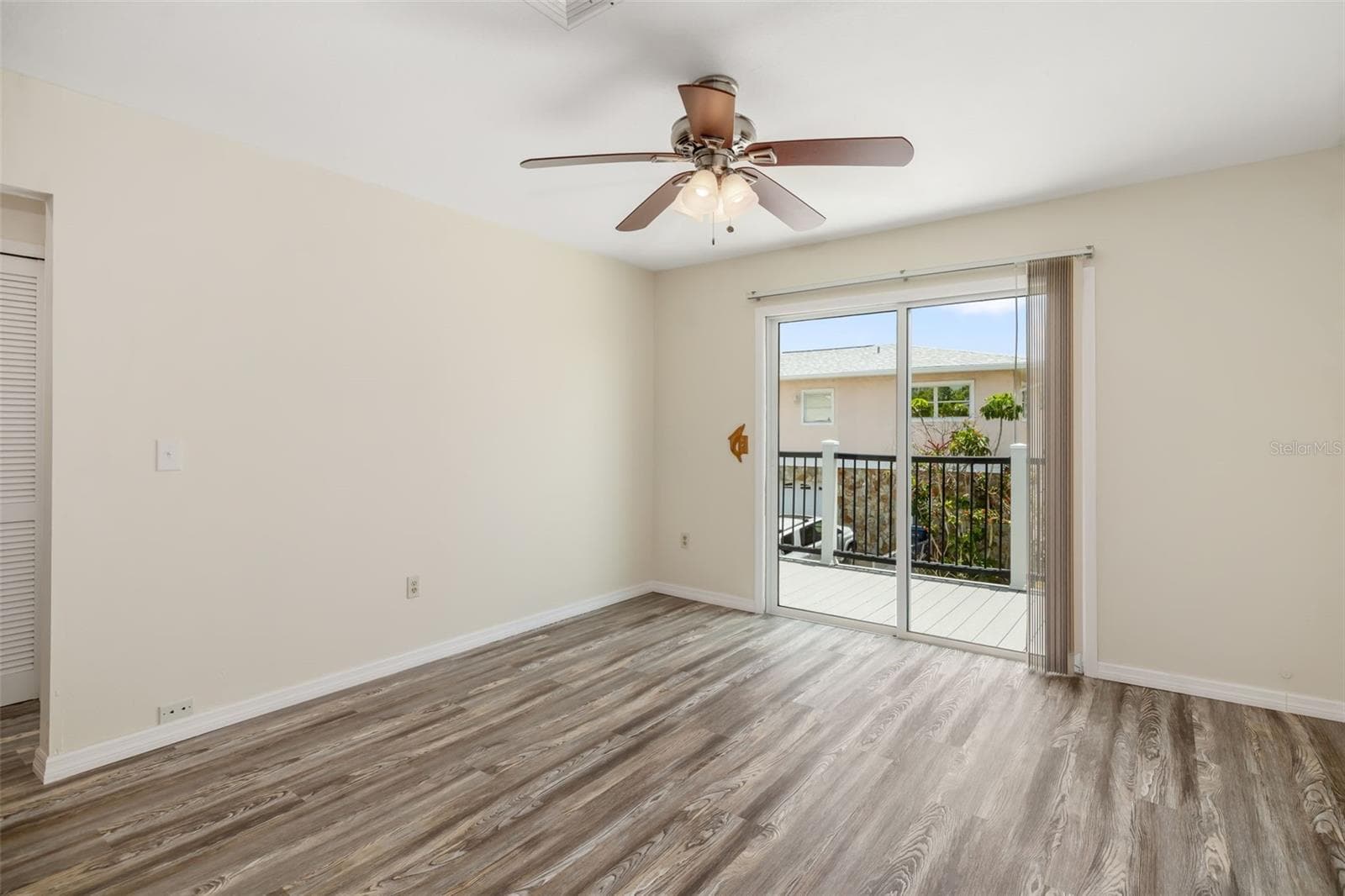 Living Area – Wide Open ViewSpacious open-concept living area with durable flooring and flexible layout for everyday living or entertaining.Sliding glass doors connect interior living space to the expansive outdoor deck. - 2513 AVENUE B #B, BRADENTON BEACH