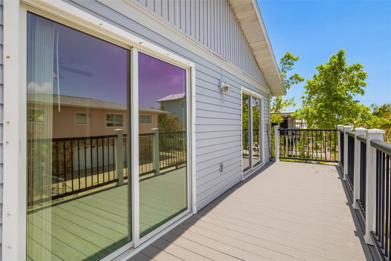 Deck View – Neighboring HomesElevated deck overlooking the surrounding neighborhood with coastal breezes and outdoor living space.Private elevated deck with neighborhood views and plenty of room for outdoor seating. - 2513 AVENUE B #B, BRADENTON BEACH