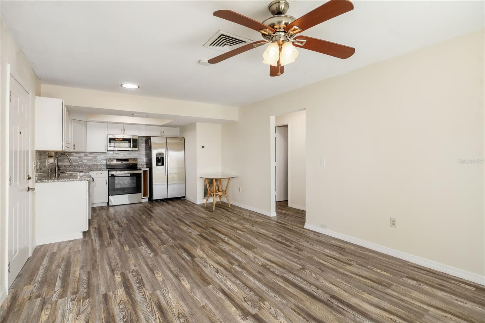 Living Room to Kitchen FlowOpen living and kitchen layout designed for easy flow and comfortable living. - 2513 AVENUE B #B, BRADENTON BEACH