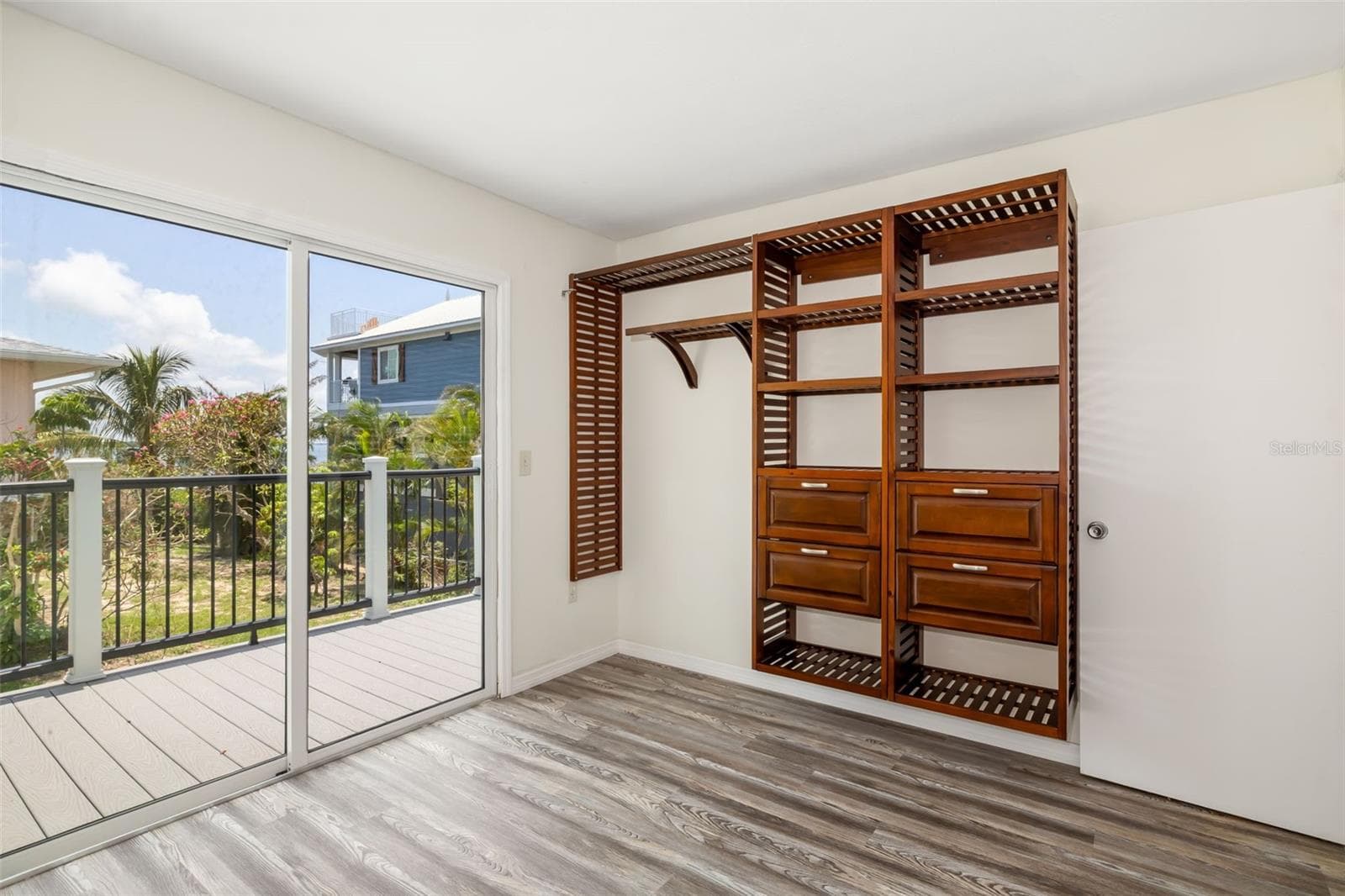 Bedroom with Deck AccessBedroom with direct sliding glass door access to the outdoor deck for indoor-outdoor living. - 2513 AVENUE B #B, BRADENTON BEACH