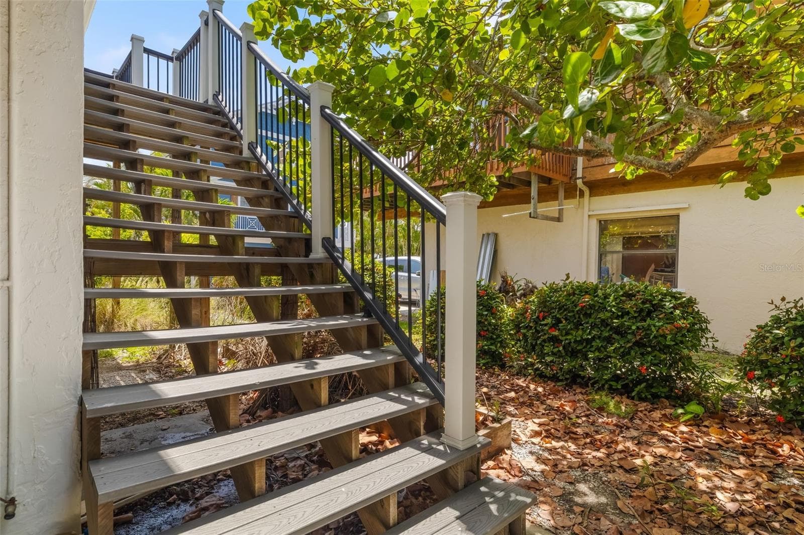 Private staircase leading to the main living area above, enhancing the elevated coastal design. - 2513 AVENUE B #B, BRADENTON BEACH