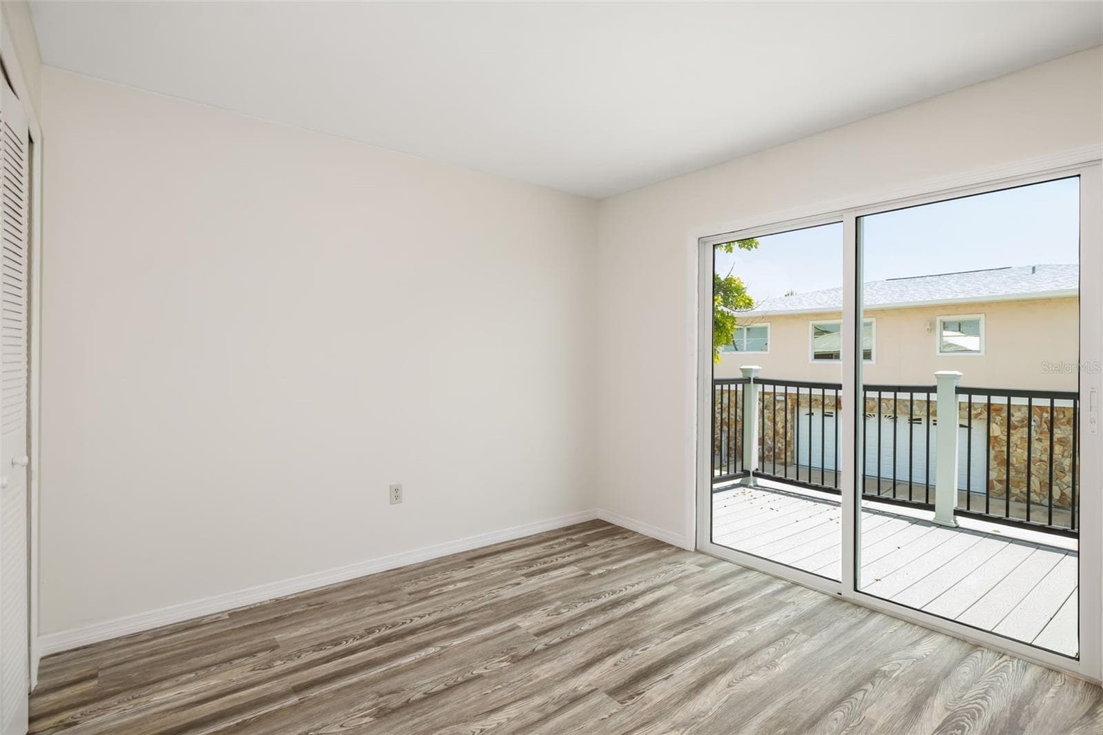 Bedroom / Flex SpaceSpacious bedroom with direct access to the outdoor deck for indoor-outdoor living. - 2513 AVENUE B #B, BRADENTON BEACH