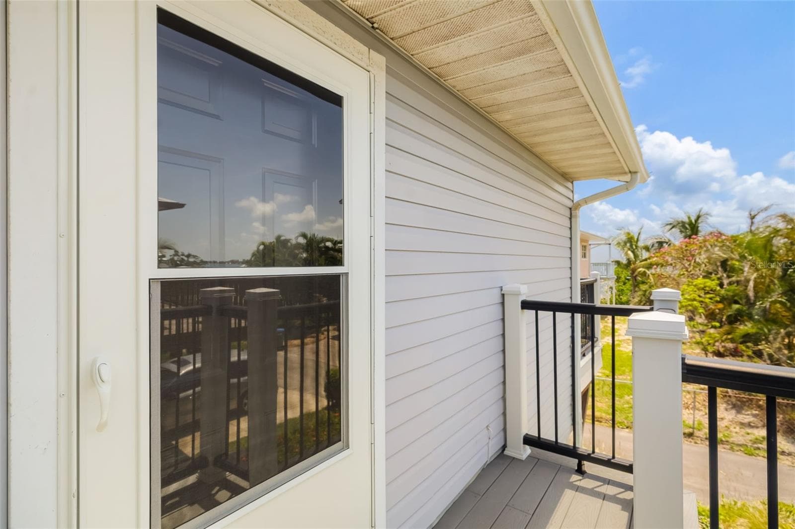 Updated staircase with durable finishes leading to the main living space. - 2513 AVENUE B #B, BRADENTON BEACH