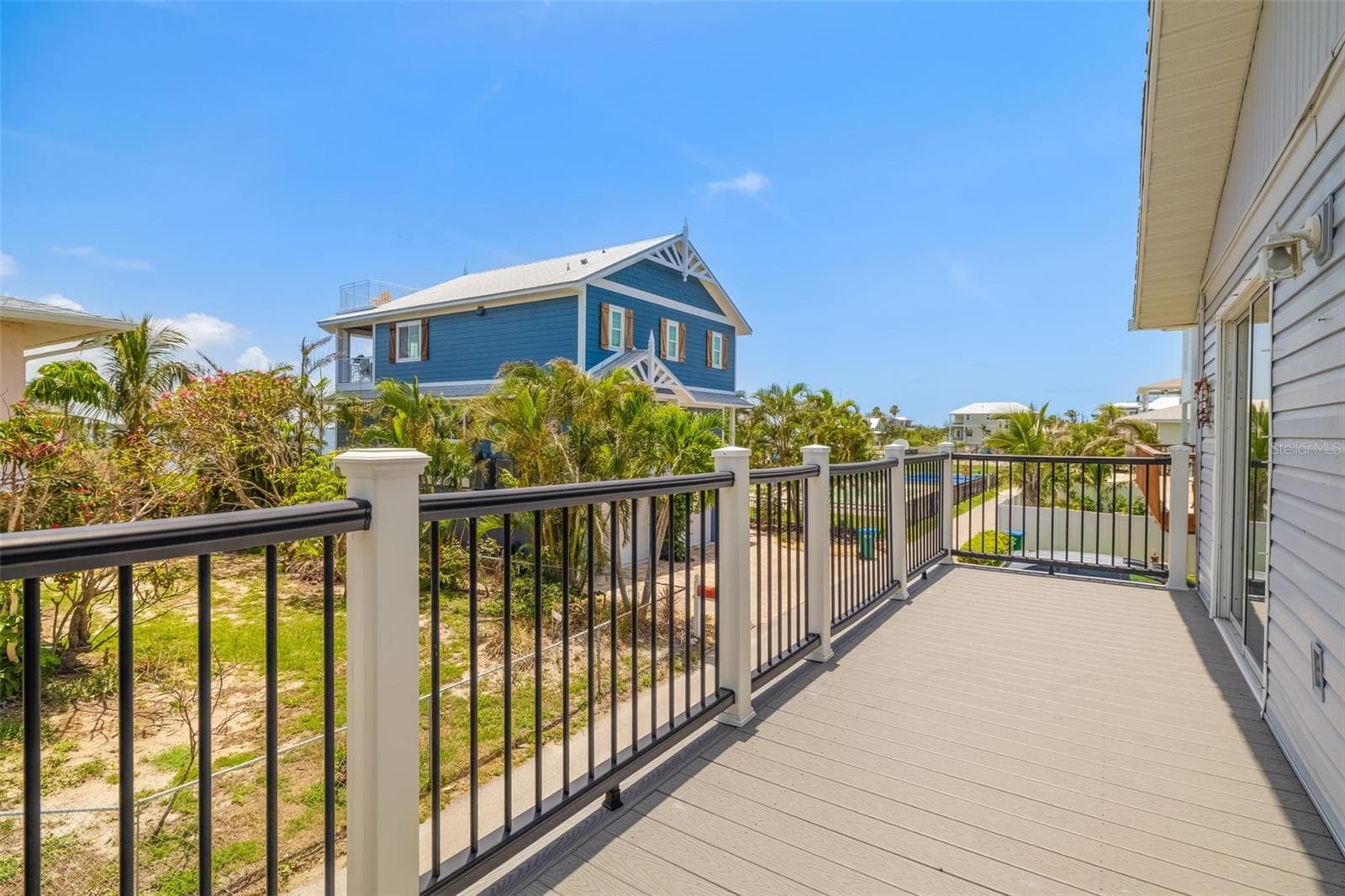 Private elevated deck ideal for outdoor dining, relaxing, and enjoying coastal breezes year-round.Generous outdoor deck space perfect for entertaining, relaxing, or enjoying coastal breezes. - 2513 AVENUE B #B, BRADENTON BEACH