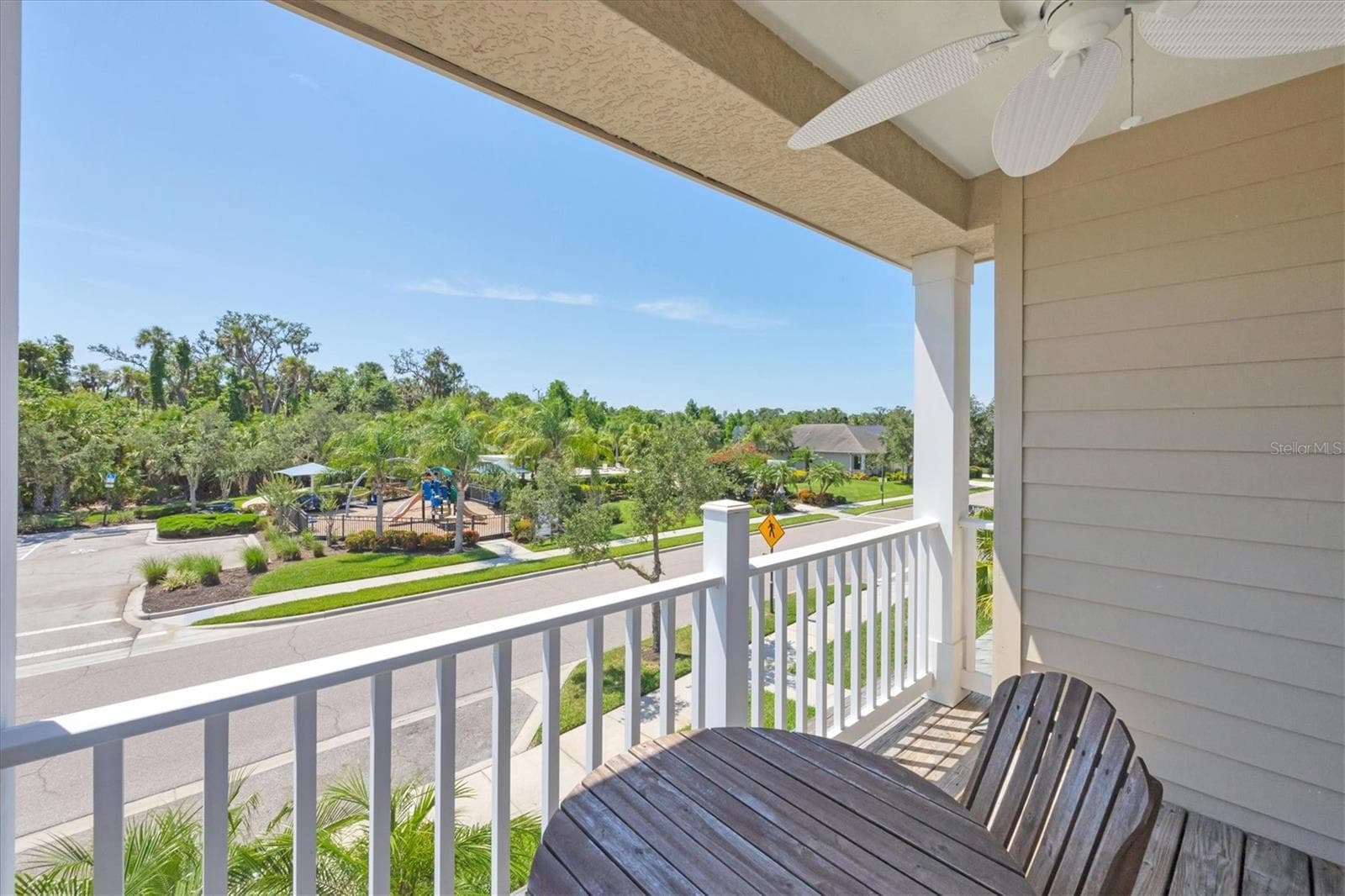 Second floor porch off primary- view of community pool/clubhouse from home - 4811 WOODBROOK DR, SARASOTA