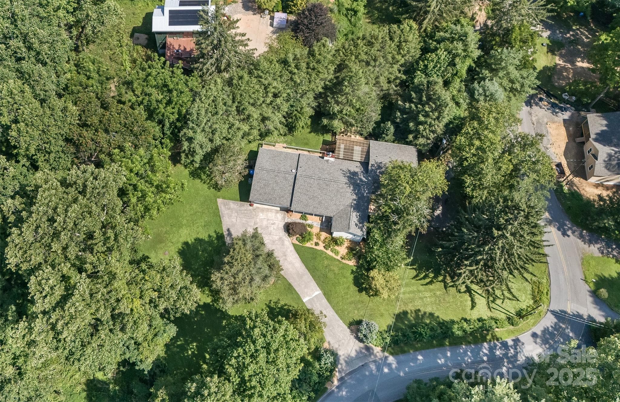 Located just off Beaverdam Road, the home is situated on over an acre with a concrete upper driveway and asphalt lower driveway. - Asheville