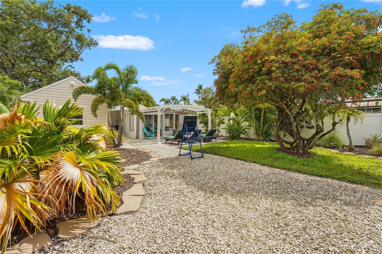 Style Setting – With low-maintenance landscaping, generous patio space, and mature palms, the backyard gives off full vacation mode—without ever leaving home. - 2705 2ND AVE W, BRADENTON