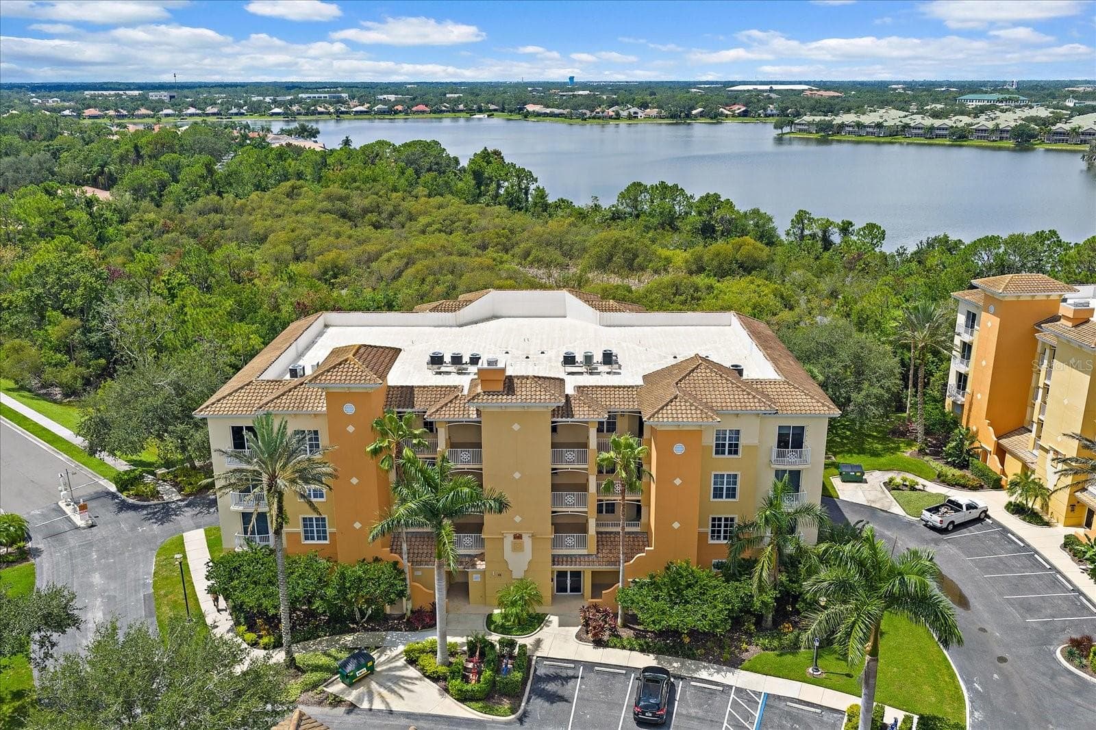 Aerial view of the building with water views - 6482 WATERCREST WAY #204, LAKEWOOD RANCH