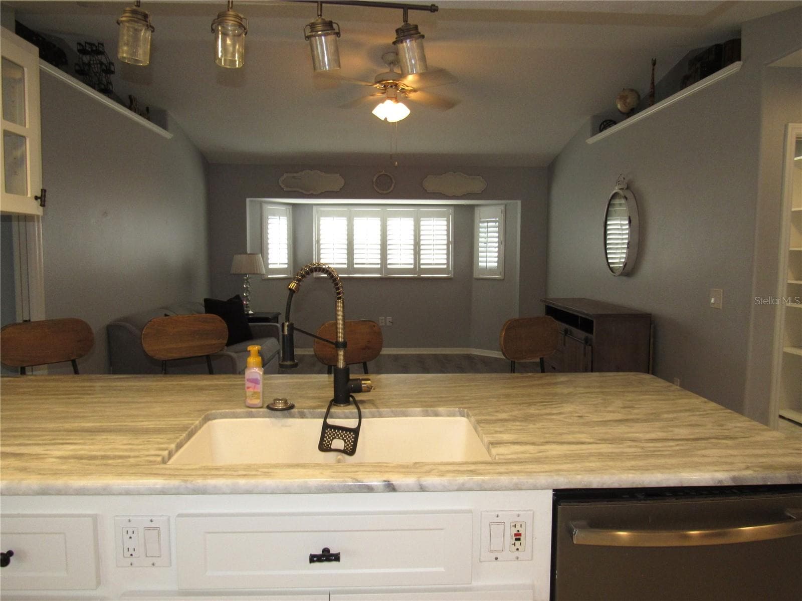View from kitchen into family room - 23081 AMBASSADOR AVE, PORT CHARLOTTE