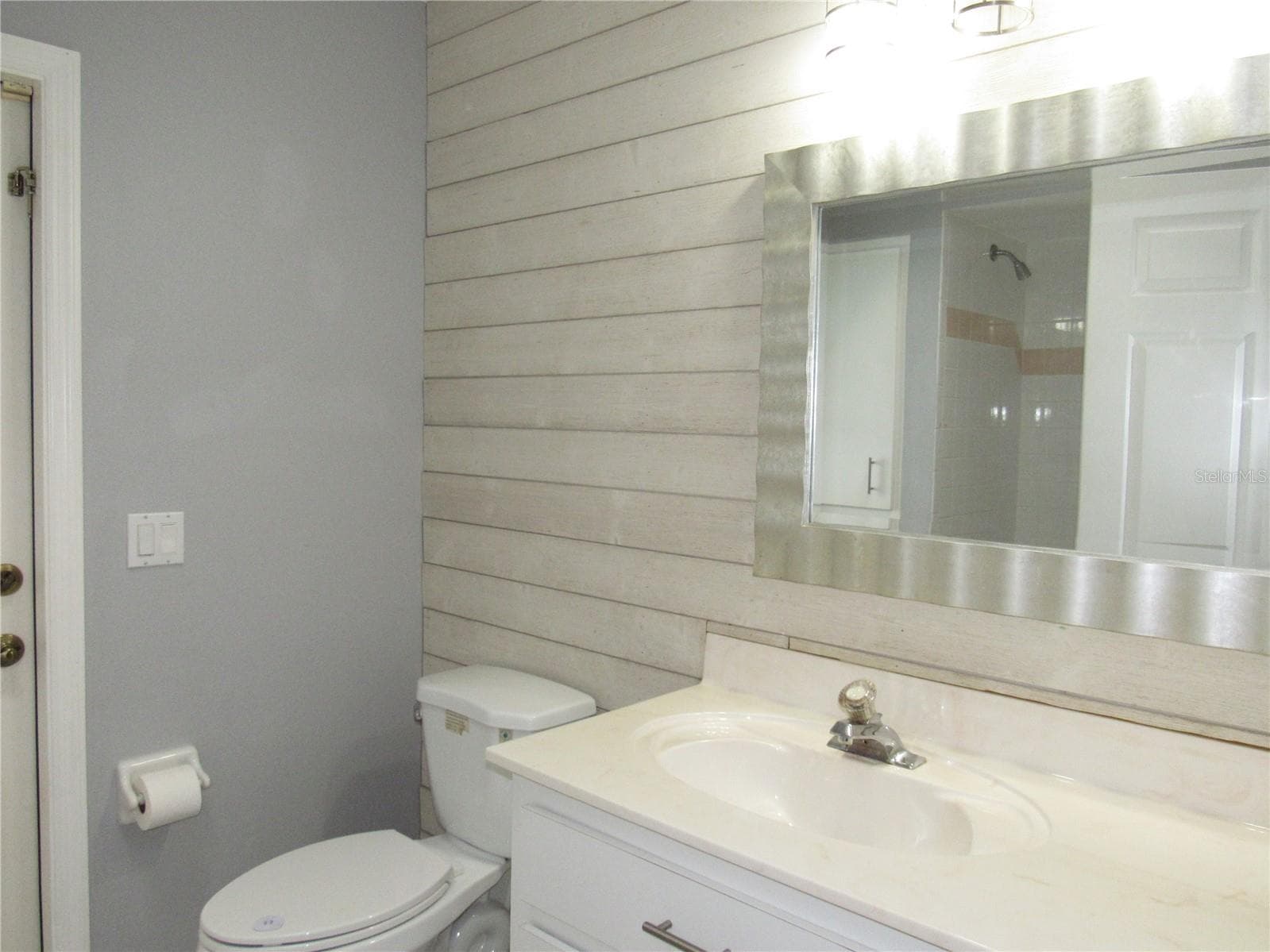 Guest bath with access door to lanai - 23081 AMBASSADOR AVE, PORT CHARLOTTE