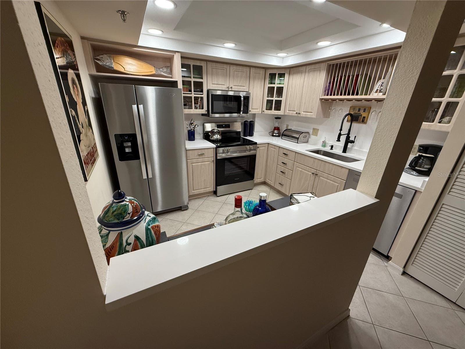 "Lean In (Leaning) Bar" - the added quartz here - makes this pass through more usable as a place to congregate - chat with the check - or just chat from Kitchen to dining / living room space when having guests over - 1 KEY CAPRI #502E, TREASURE ISLAND