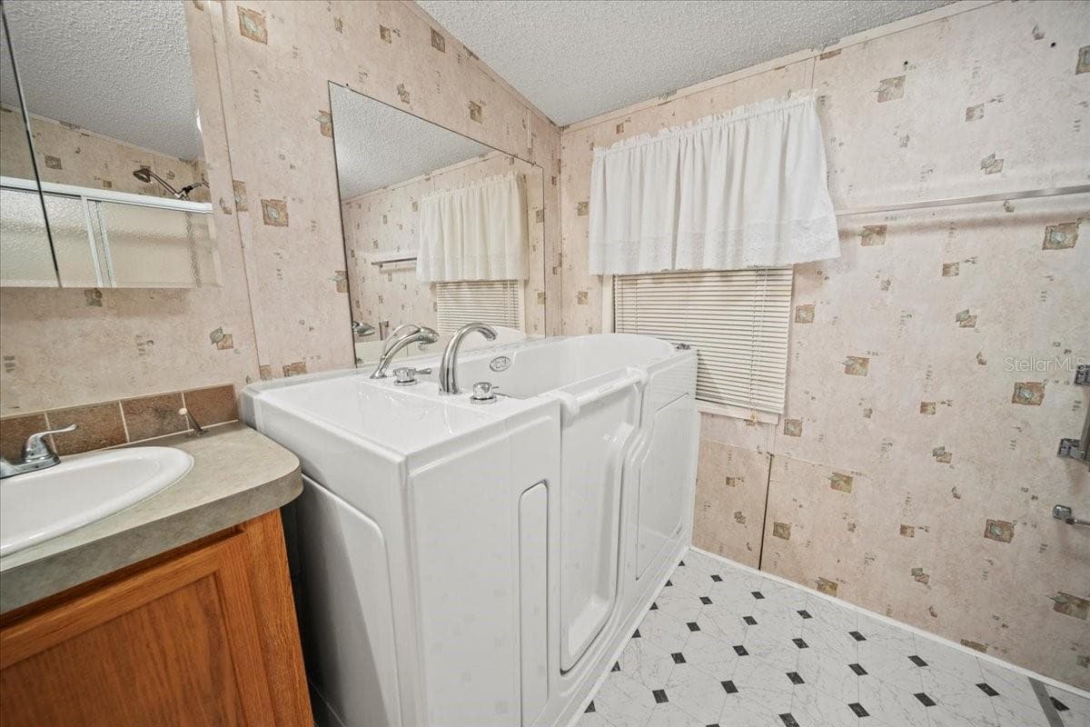 Check out this brand-new Safe Step Walk-In Tub in the primary bathroom - 101 EDGEWOOD BLVD, LAKE WALES