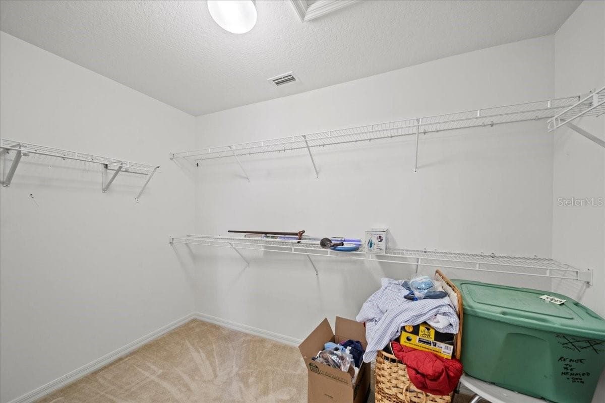 Primary bedroom closet - 364 LAKE SUZANNE DR, LAKE WALES
