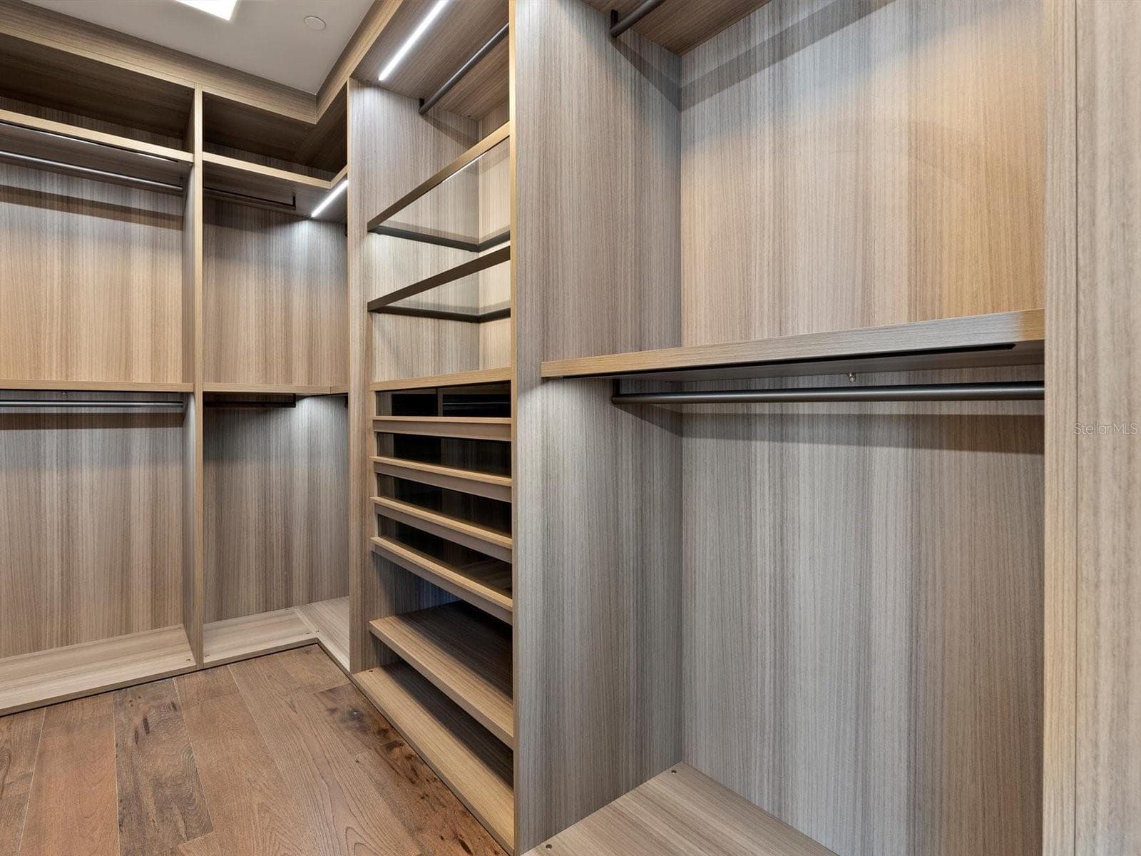 Master Walk-In Closet with custom Italian built-ins - 1020 SUNSET POINT RD #103, CLEARWATER