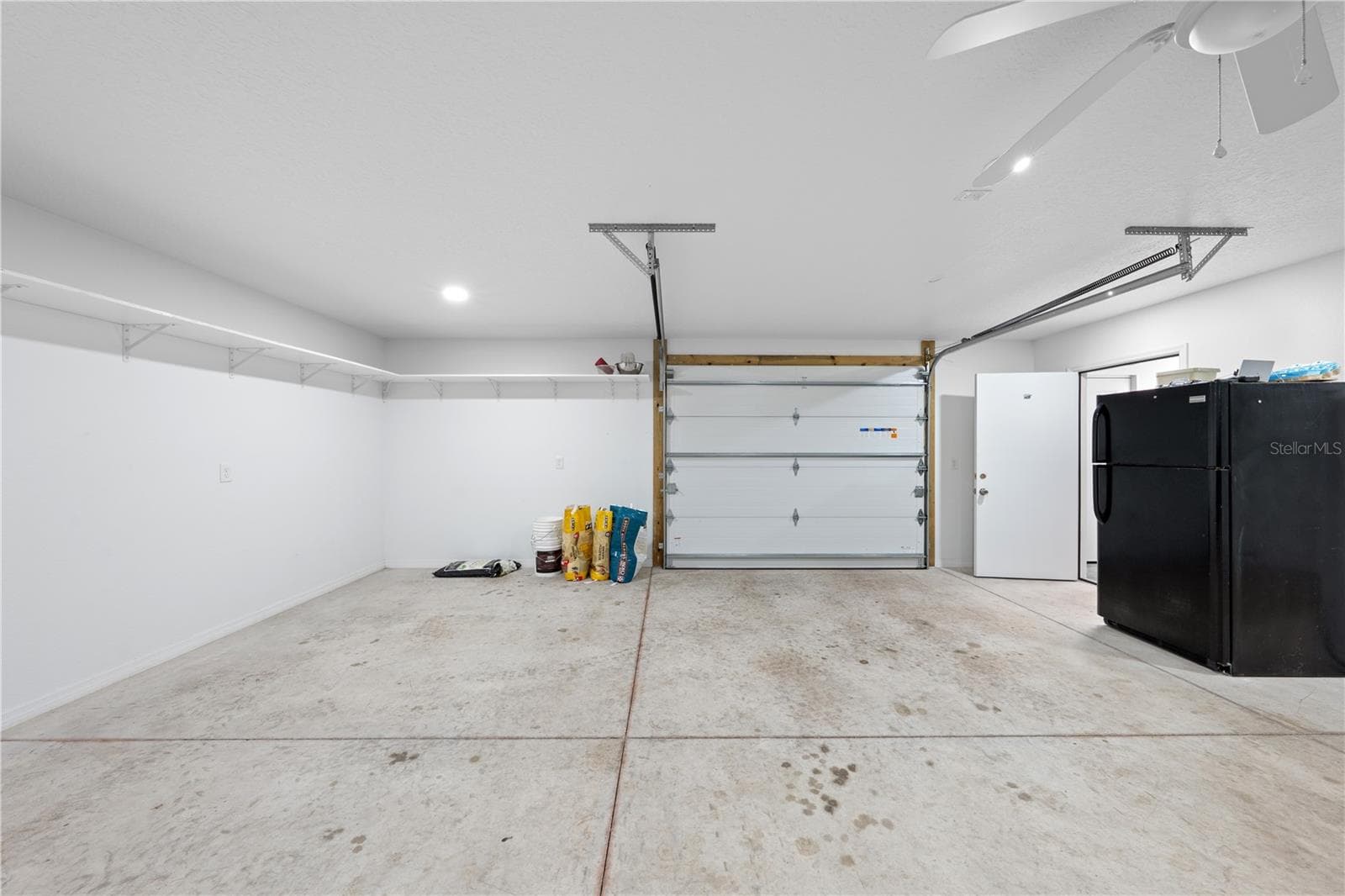 Inside of garage with bathroom, a/c, attic space, electric and water that is attached to the in-law suite photo 2 - 4055 EDSEL AVE, ST CLOUD