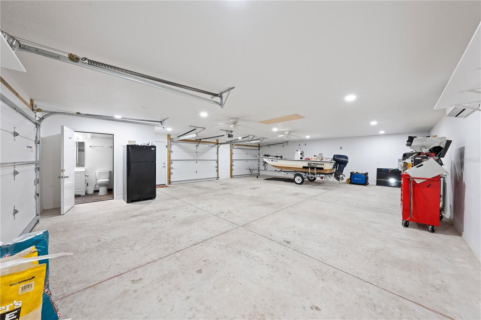 Inside of garage with bathroom, a/c, attic space, electric and water that is attached to the in-law suite photo 3 - 4055 EDSEL AVE, ST CLOUD