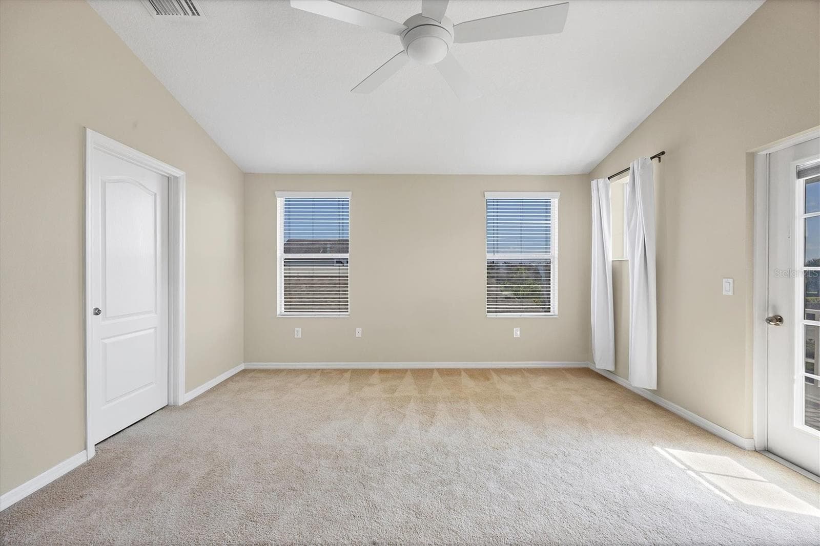 Primary suite features vaulted ceilings and new fan - 4811 WOODBROOK DR, SARASOTA
