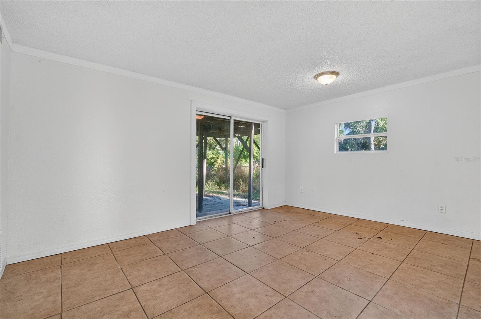 Primary bedroom has glass sliders to river-front yard. - 6345 LOST TRL, HOLIDAY
