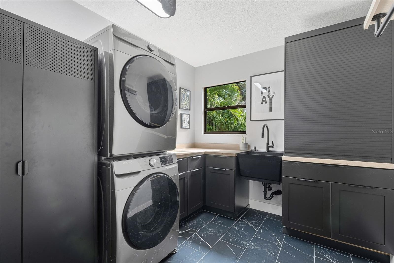 quaint laundry room has natural light and a peaceful view - 6349 RAVENWOOD WAY, SARASOTA