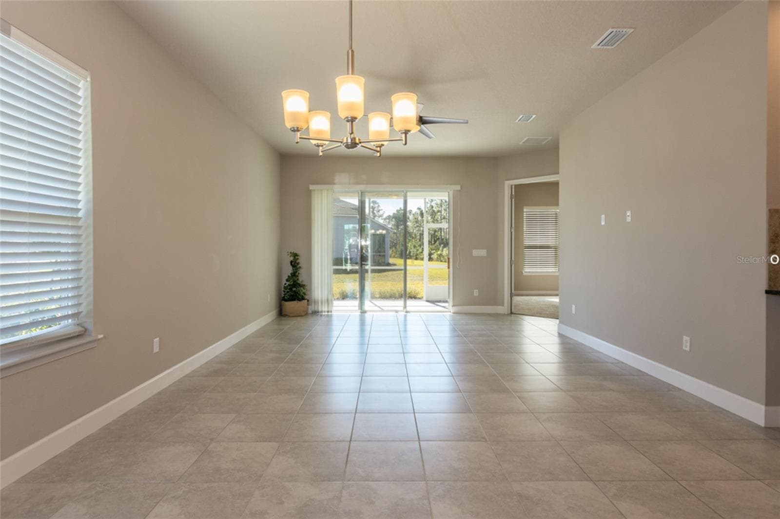 Open concept -- view from dining area looking towards living area and lanai - 3 NEWHAVEN LN, ORMOND BEACH