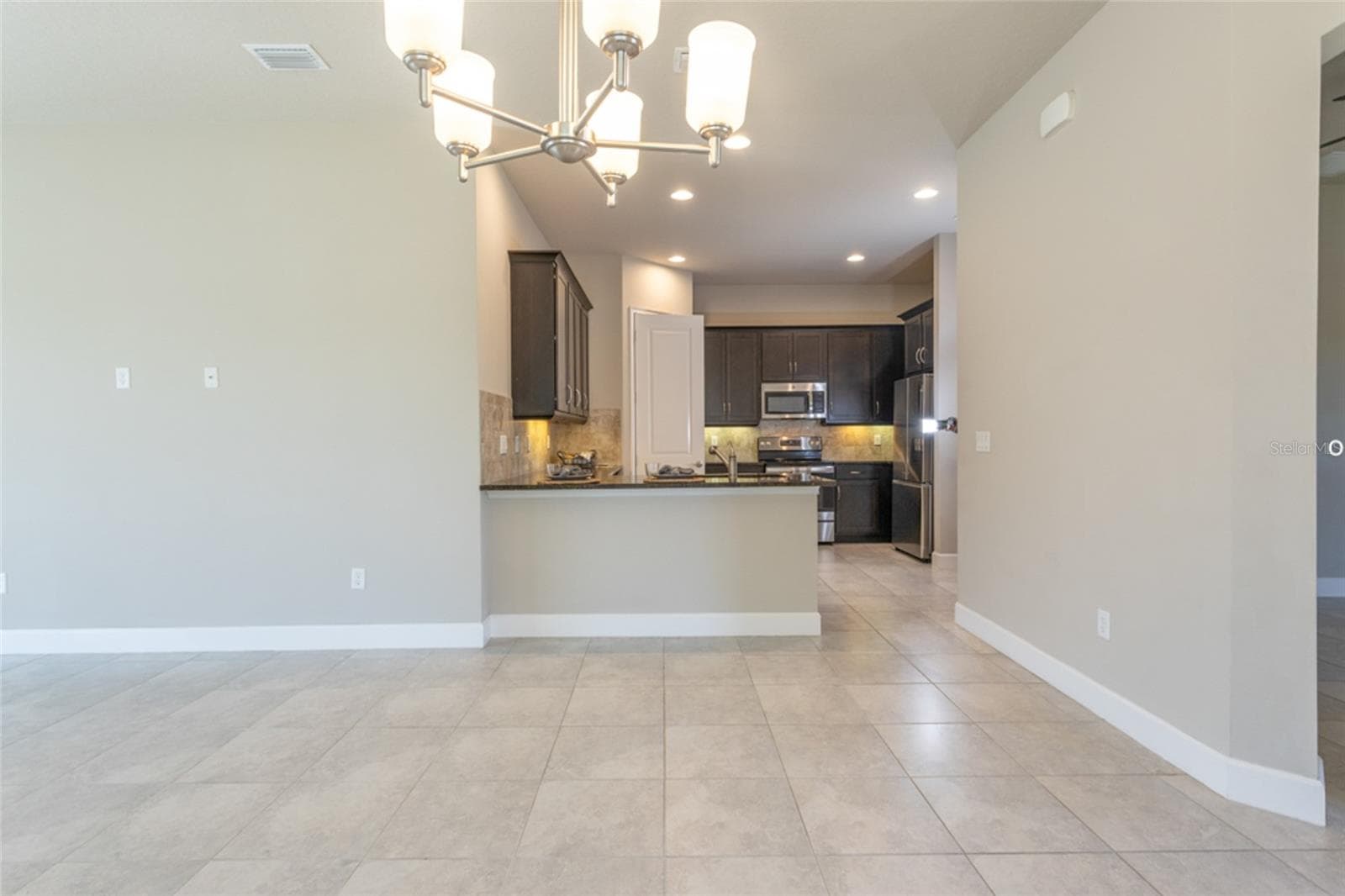 Open concept -- view from dining area into kitchen - 3 NEWHAVEN LN, ORMOND BEACH